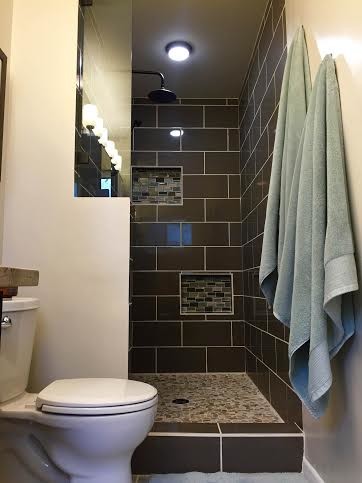 Inredning av ett modernt litet en-suite badrum, med ett fristående handfat, släta luckor, skåp i mörkt trä, granitbänkskiva, en öppen dusch, en toalettstol med separat cisternkåpa, brun kakel, keramikplattor, beige väggar och klinkergolv i keramik