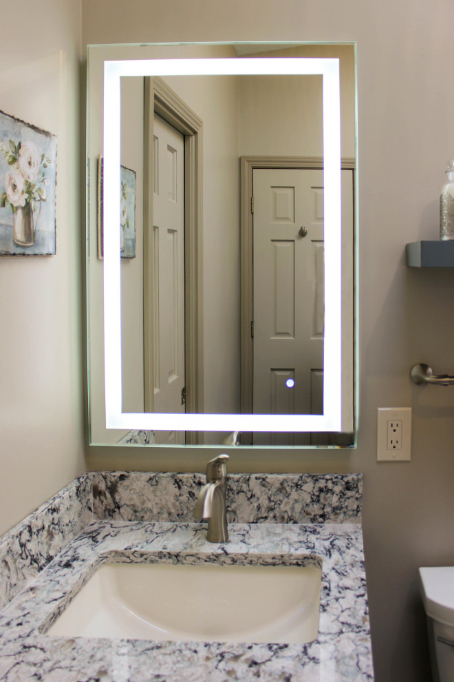 Inspiration for a small transitional master porcelain tile and gray floor corner shower remodel in Cleveland with raised-panel cabinets, green cabinets, a two-piece toilet, beige walls, an undermount sink, quartz countertops, a hinged shower door and multicolored countertops