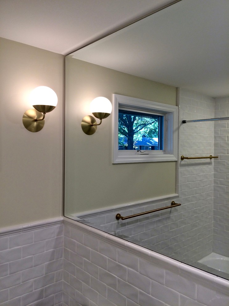 This is an example of a small classic bathroom in Kansas City with freestanding cabinets, grey cabinets, an alcove bath, a one-piece toilet, white tiles, metro tiles, yellow walls, mosaic tile flooring and a console sink.