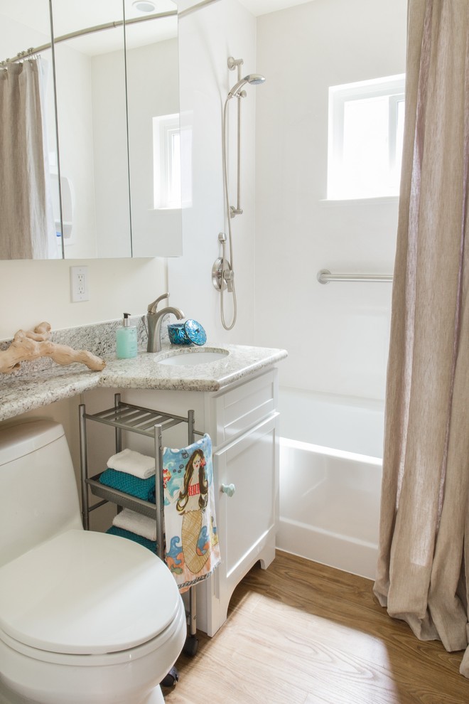 Bathroom - small coastal kids' gray tile vinyl floor bathroom idea in San Diego with an undermount sink, shaker cabinets, white cabinets, granite countertops, a one-piece toilet, white walls and yellow countertops