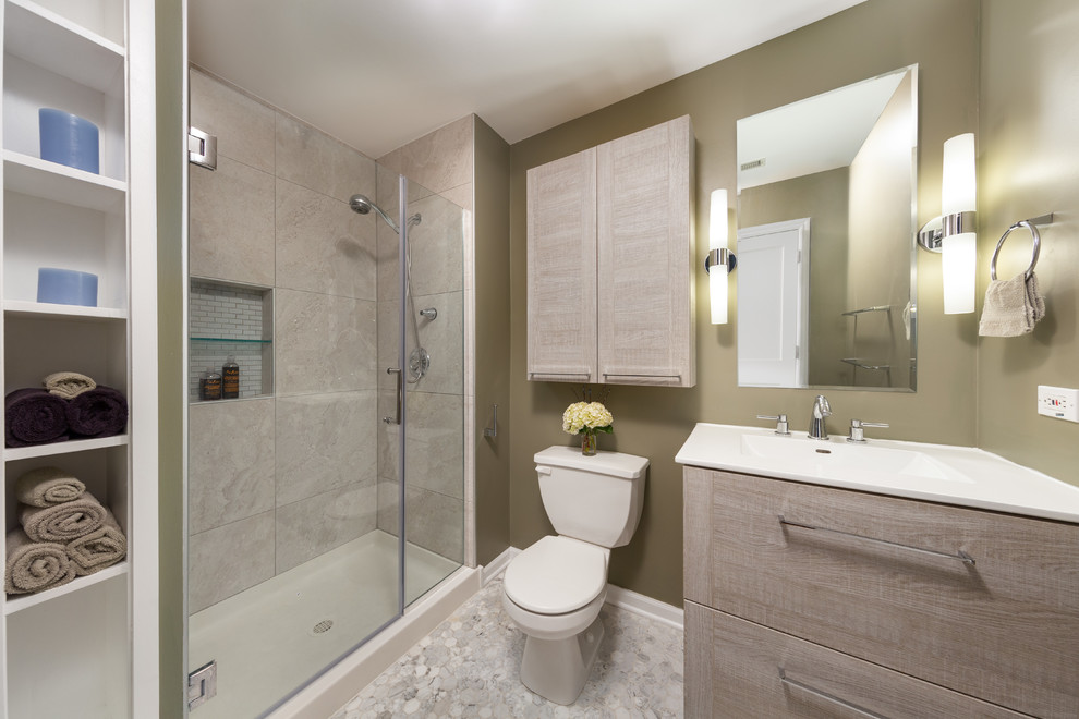 Mid-sized transitional 3/4 gray tile and stone tile mosaic tile floor alcove shower photo in Chicago with flat-panel cabinets, medium tone wood cabinets, a two-piece toilet, beige walls, an integrated sink and marble countertops