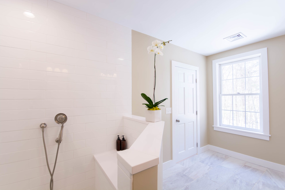 Large classic ensuite bathroom in Providence with shaker cabinets, dark wood cabinets, white tiles, metro tiles, beige walls, porcelain flooring, a submerged sink, engineered stone worktops, beige floors, an open shower and white worktops.