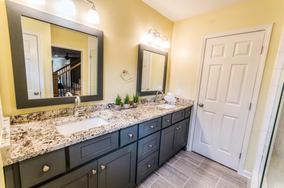 Photo of a medium sized country bathroom in Atlanta with shaker cabinets, grey cabinets, a walk-in shower, white tiles, ceramic tiles, yellow walls, porcelain flooring, a submerged sink and granite worktops.