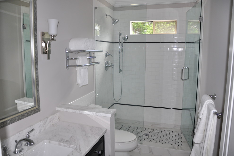 Inspiration for a small timeless 3/4 white tile and ceramic tile marble floor and white floor doorless shower remodel in Atlanta with raised-panel cabinets, black cabinets, a two-piece toilet, gray walls, an undermount sink, marble countertops and a hinged shower door