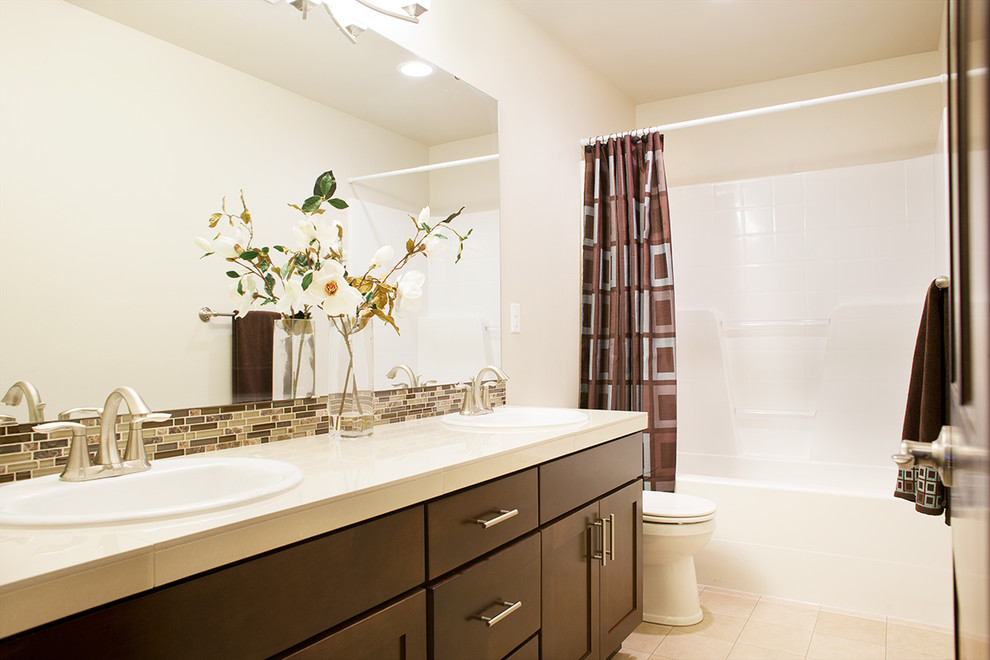 Mid-sized elegant kids' multicolored tile and mosaic tile ceramic tile bathroom photo in Seattle with recessed-panel cabinets, dark wood cabinets, a one-piece toilet, beige walls, a drop-in sink and quartz countertops