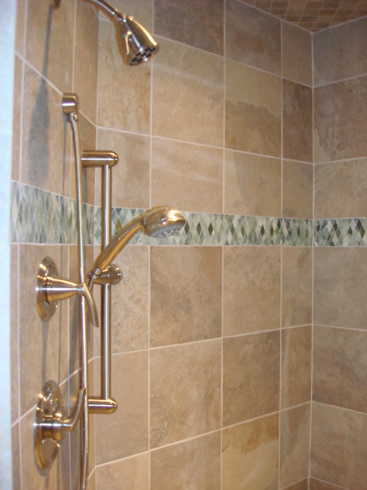 Example of a large trendy green tile corner shower design in Denver with an undermount sink, flat-panel cabinets, light wood cabinets, granite countertops and an undermount tub