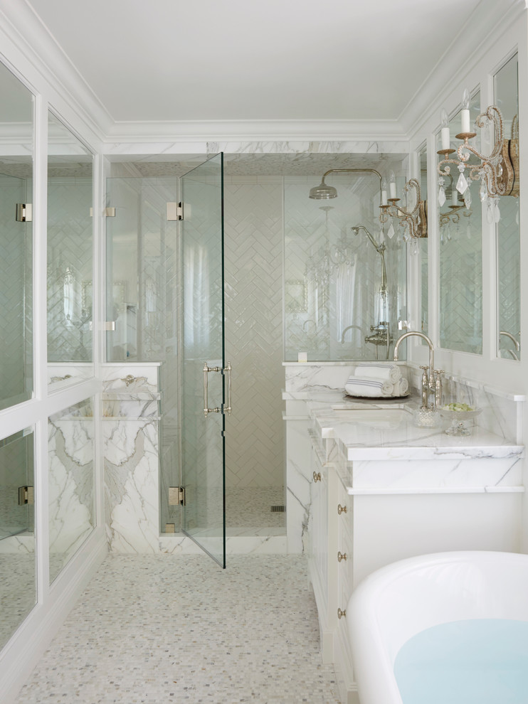 Inspiration for a traditional bathroom in Orange County with white cabinets, a freestanding bath, an alcove shower, white tiles, mosaic tile flooring and a submerged sink.