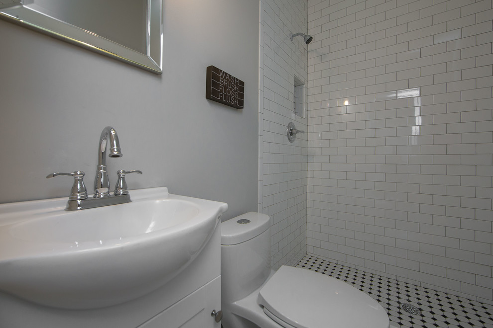 Inspiration for a mid-sized transitional 3/4 white tile and porcelain tile bathroom remodel in Richmond with shaker cabinets, white cabinets, a two-piece toilet, gray walls, an integrated sink and solid surface countertops