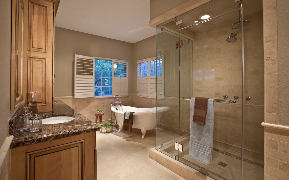 Пример оригинального дизайна: ванная комната в классическом стиле с ванной на ножках, столешницей из гранита и врезной раковиной