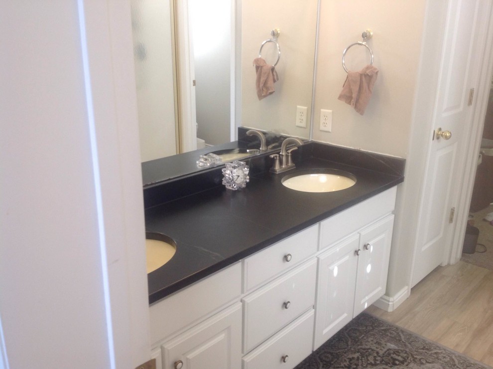 Medium sized traditional bathroom in Salt Lake City with a submerged sink, soapstone worktops, raised-panel cabinets, white cabinets, a built-in bath and beige walls.