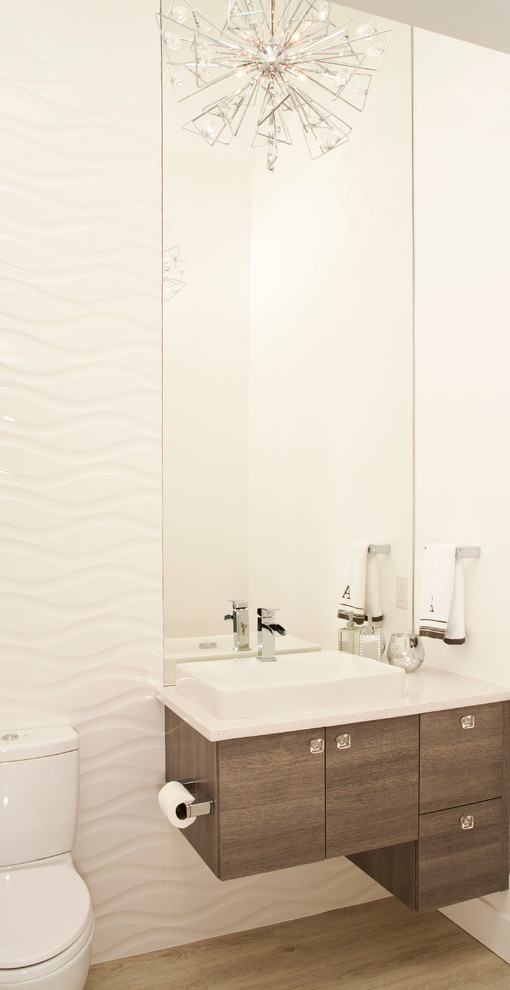Diseño de cuarto de baño actual con armarios con paneles lisos, lavabo sobreencimera y suelo de madera oscura