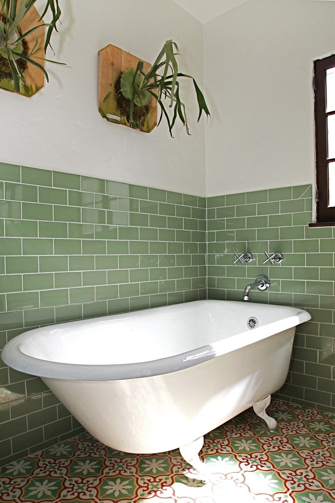 Photo of a traditional bathroom in Los Angeles with a claw-foot bath, dark wood cabinets, a walk-in shower, green tiles, ceramic tiles, white walls, cement flooring, a submerged sink, engineered stone worktops, multi-coloured floors, a hinged door and beige worktops.