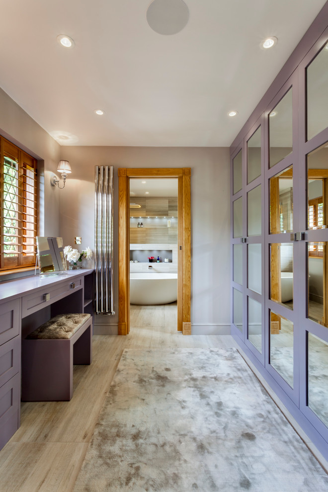 Large contemporary ensuite bathroom in Sussex with flat-panel cabinets, light wood cabinets, a freestanding bath, a walk-in shower, a two-piece toilet, grey tiles, stone slabs, grey walls, limestone flooring, a built-in sink and marble worktops.