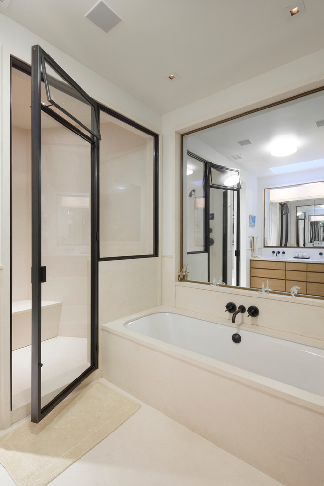 Design ideas for a large modern ensuite bathroom in New York with flat-panel cabinets, medium wood cabinets, an alcove bath, an alcove shower, beige tiles, ceramic tiles, white walls, porcelain flooring, beige floors and a hinged door.
