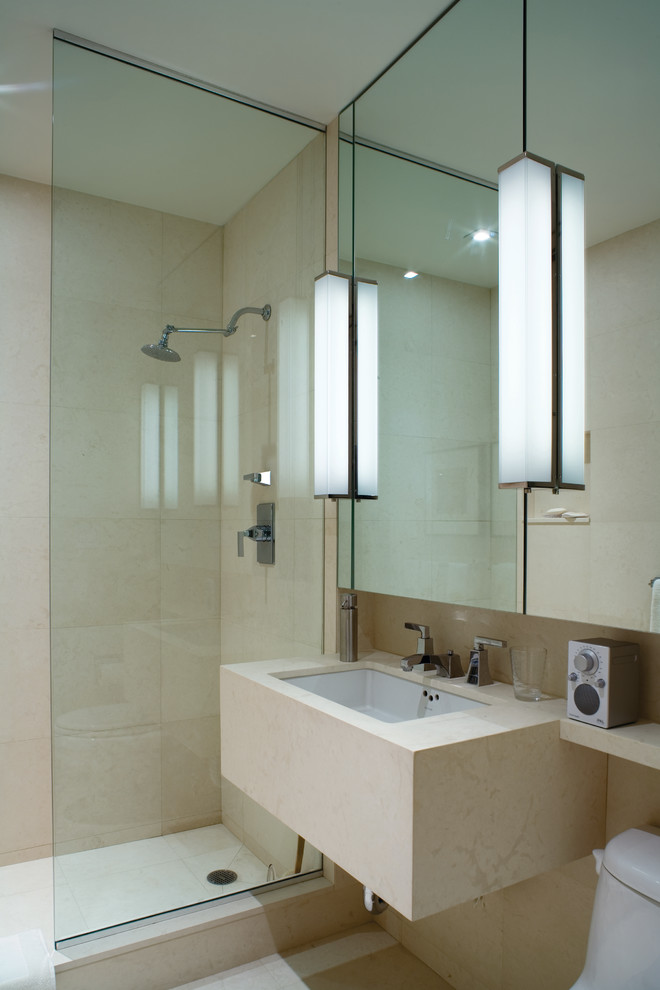 Example of a trendy bathroom design in New York with an undermount sink and beige countertops