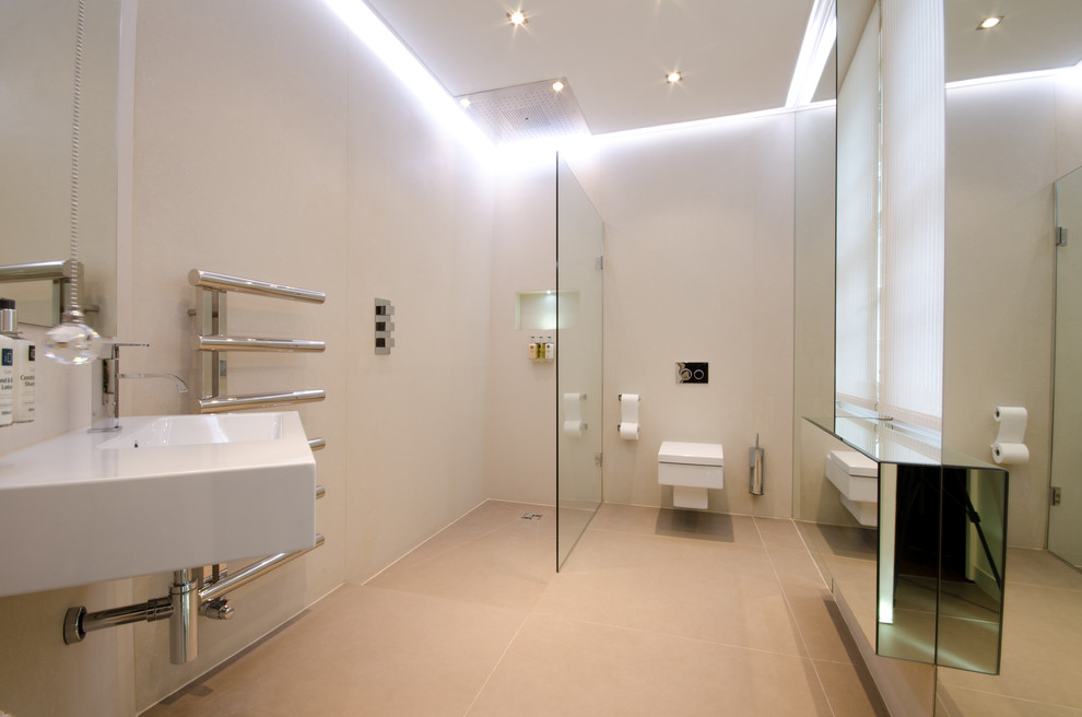 Contemporary ensuite bathroom in London with a walk-in shower, a wall mounted toilet, beige tiles, porcelain tiles, beige walls, porcelain flooring and a wall-mounted sink.