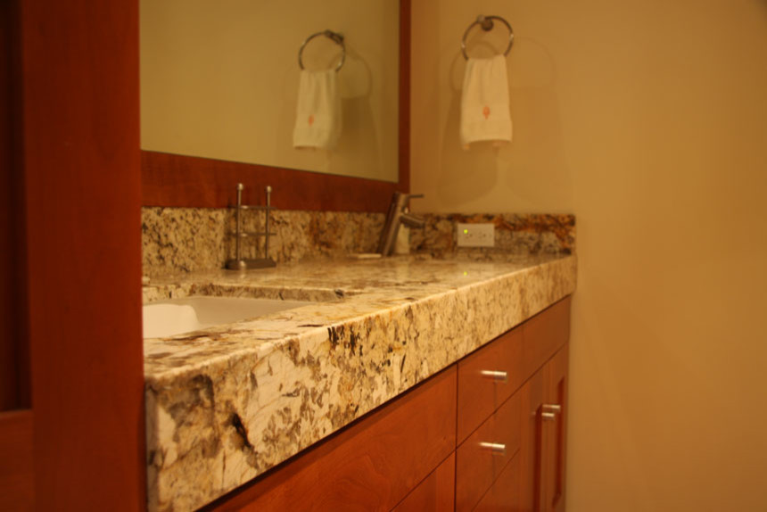 Example of a large trendy 3/4 marble tile bathroom design in San Diego with flat-panel cabinets, marble countertops, light wood cabinets, a two-piece toilet, beige walls and a drop-in sink