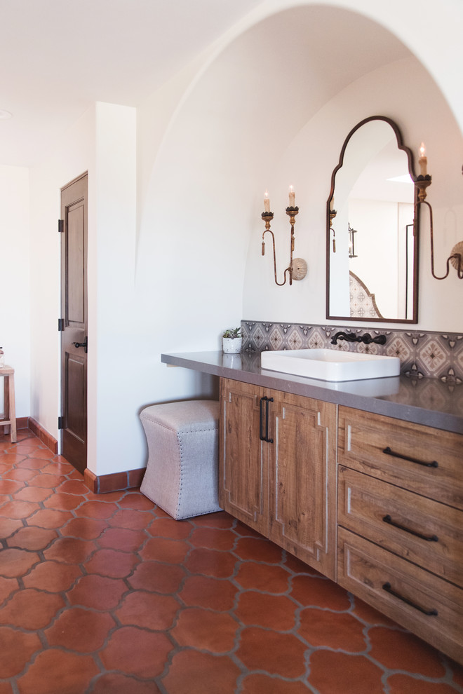 Example of a huge southwest master multicolored tile and ceramic tile terra-cotta tile and orange floor bathroom design in San Diego with raised-panel cabinets, medium tone wood cabinets, white walls, a vessel sink, a hinged shower door and gray countertops