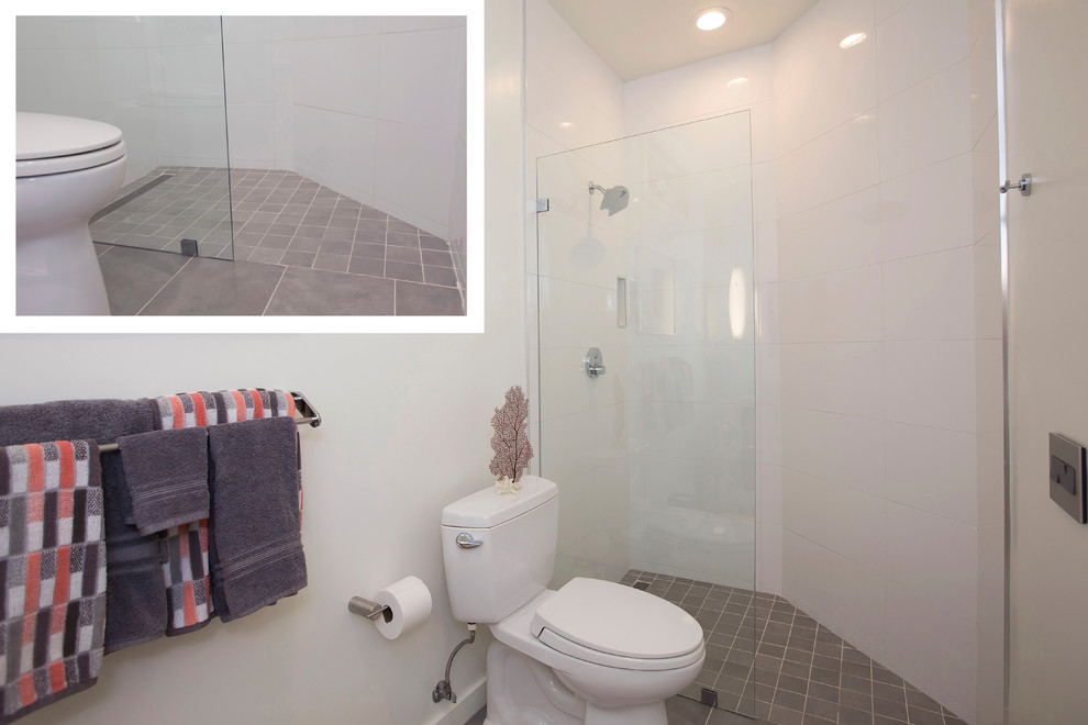 Example of a small minimalist 3/4 green tile and glass tile porcelain tile doorless shower design in San Diego with flat-panel cabinets, dark wood cabinets, a one-piece toilet, gray walls, an integrated sink and solid surface countertops