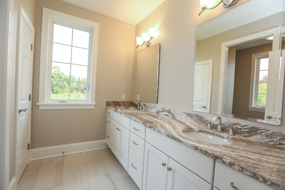 Photo of a medium sized classic ensuite bathroom in New York with recessed-panel cabinets, white cabinets, a corner shower, a two-piece toilet, white walls, ceramic flooring, a submerged sink, granite worktops, beige floors and a hinged door.
