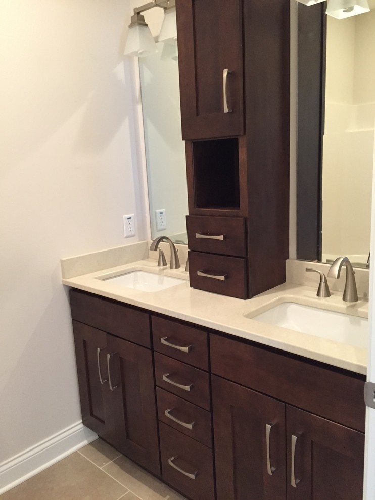 This is an example of a large traditional family bathroom in Other with shaker cabinets, dark wood cabinets, beige walls and ceramic flooring.