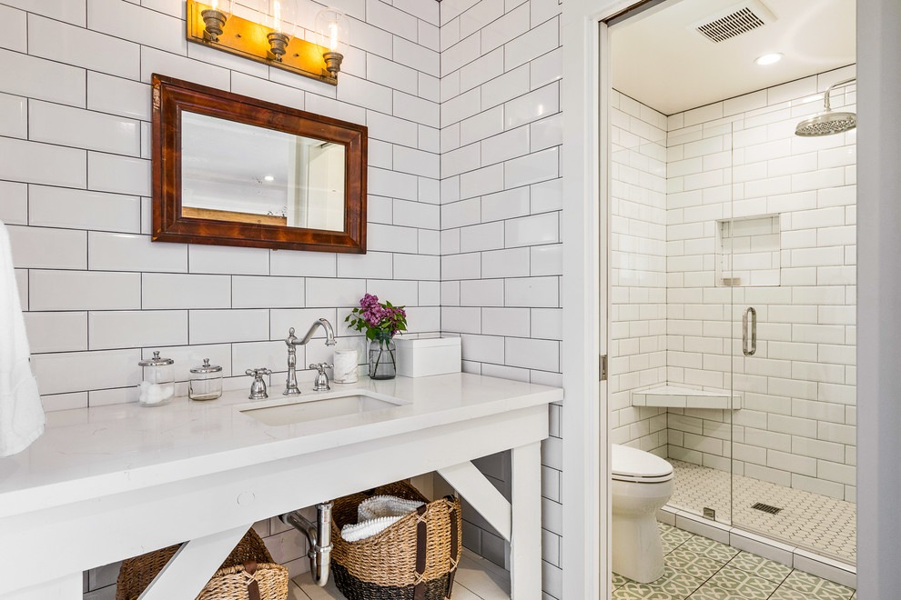 Farmhouse shower room bathroom in San Francisco with open cabinets, white cabinets, an alcove shower, white tiles, metro tiles, white walls, a submerged sink, multi-coloured floors, a hinged door and white worktops.