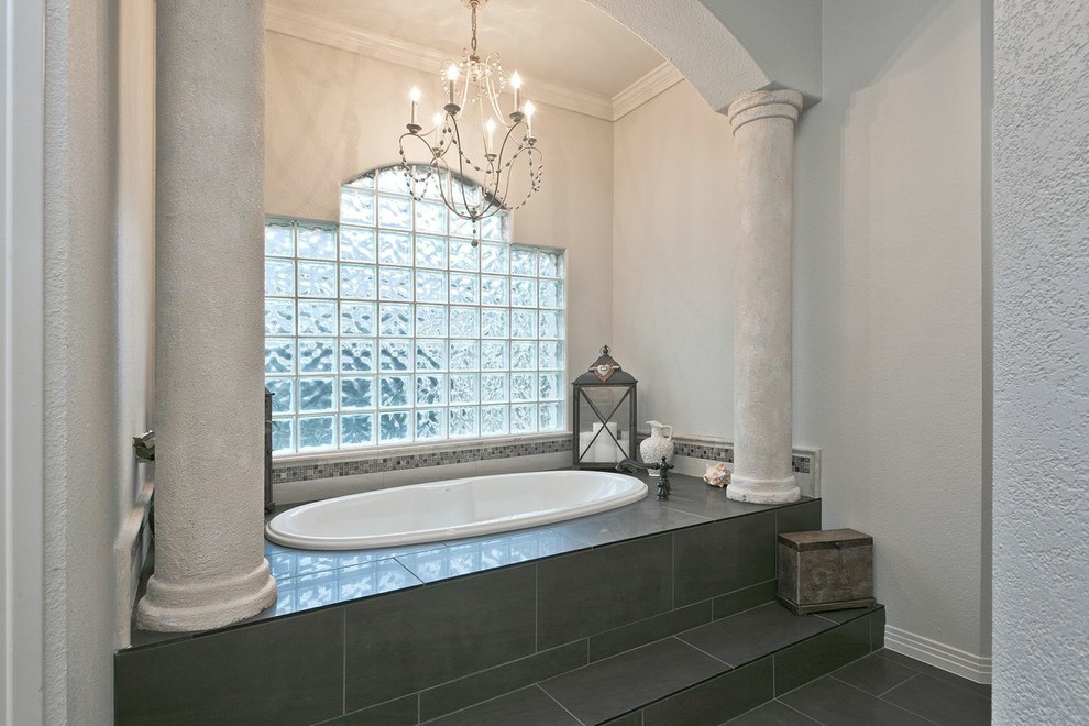 This is an example of a large traditional ensuite bathroom in Austin with a submerged sink, a built-in bath, an alcove shower, a two-piece toilet, grey tiles, ceramic tiles, beige walls and porcelain flooring.