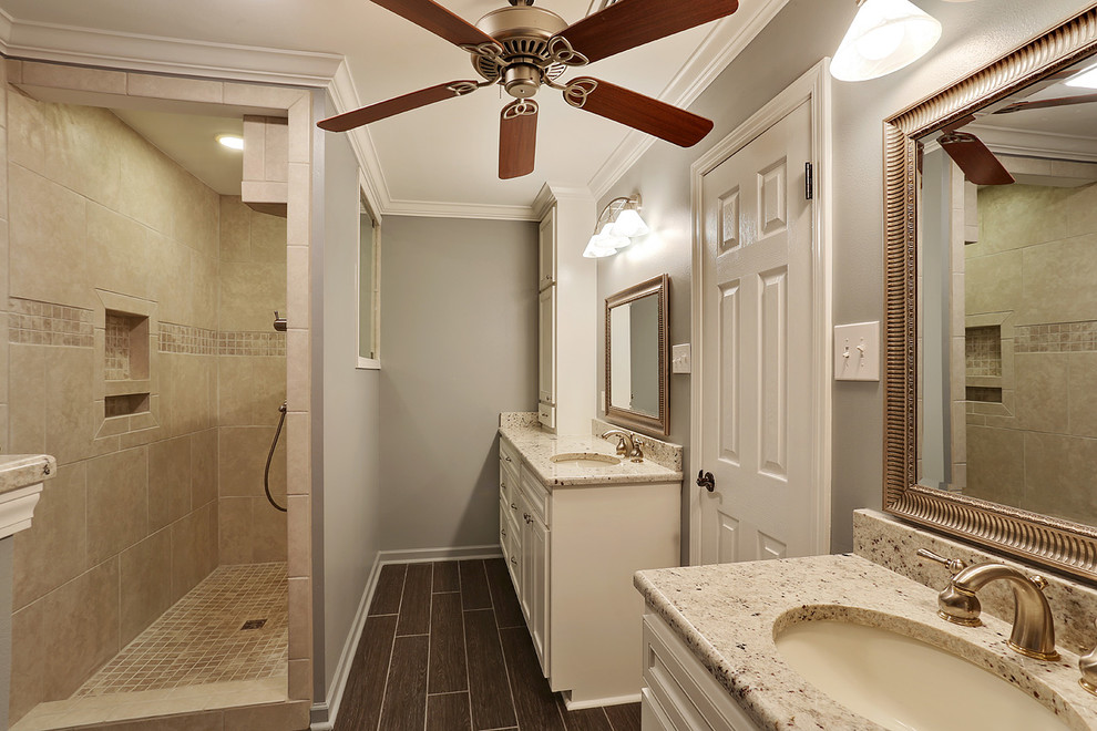 Example of a mid-sized classic master beige tile and stone tile travertine floor doorless shower design in New Orleans with an undermount sink, recessed-panel cabinets, white cabinets, granite countertops, a one-piece toilet and blue walls