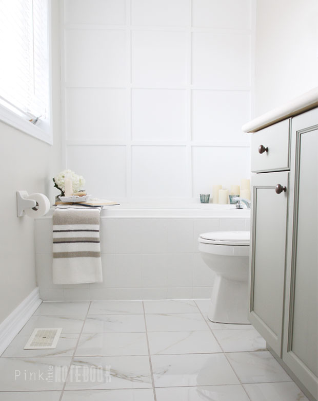 Medium sized traditional ensuite bathroom in Toronto with a built-in sink, raised-panel cabinets, grey cabinets, laminate worktops, a built-in bath, a corner shower, a two-piece toilet, white tiles, ceramic tiles, white walls and ceramic flooring.