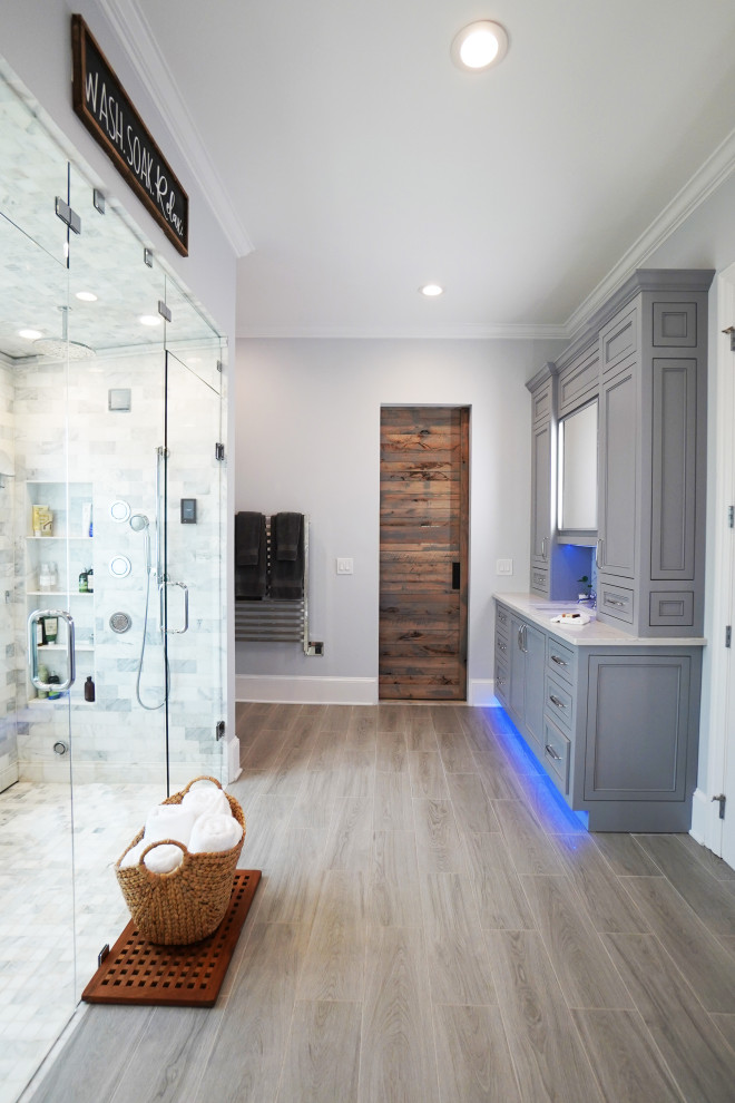 Example of a large classic master gray tile and marble tile porcelain tile and brown floor walk-in shower design in Atlanta with shaker cabinets, gray cabinets, a bidet, gray walls, an undermount sink, quartz countertops, a hinged shower door and white countertops