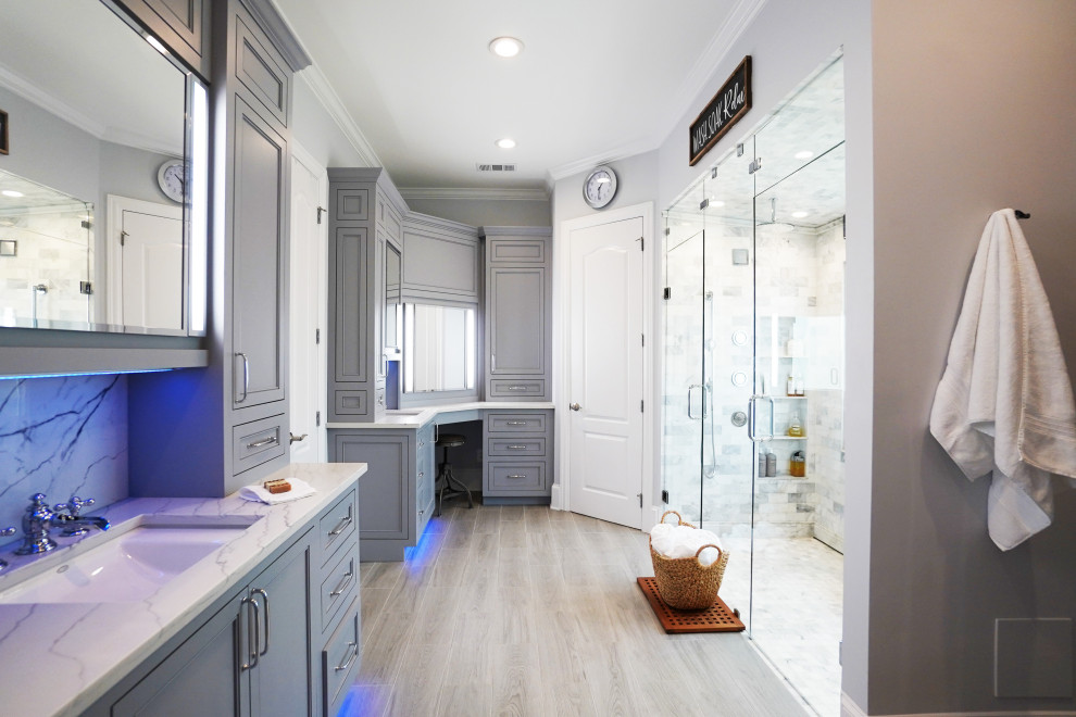 Walk-in shower - large transitional master gray tile and marble tile porcelain tile and brown floor walk-in shower idea in Atlanta with shaker cabinets, gray cabinets, a bidet, gray walls, an undermount sink, quartz countertops, a hinged shower door and white countertops