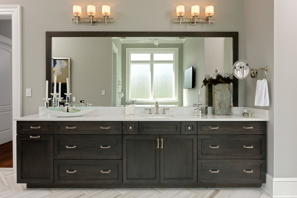 Inspiration for a large traditional ensuite bathroom in DC Metro with flat-panel cabinets, brown cabinets, a freestanding bath, a walk-in shower, a two-piece toilet, grey tiles, grey walls, porcelain flooring, a submerged sink, engineered stone worktops and white floors.