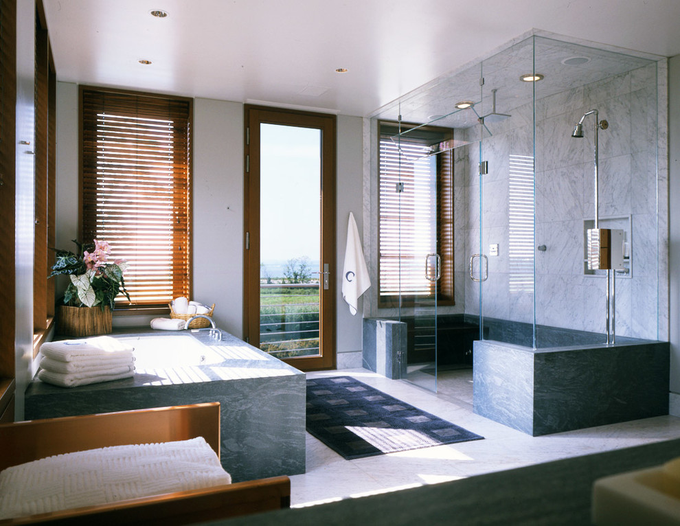 Photo of a large contemporary ensuite bathroom in New York with a built-in bath, an alcove shower, grey tiles, stone slabs, white walls, marble flooring, a submerged sink, multi-coloured floors and a hinged door.