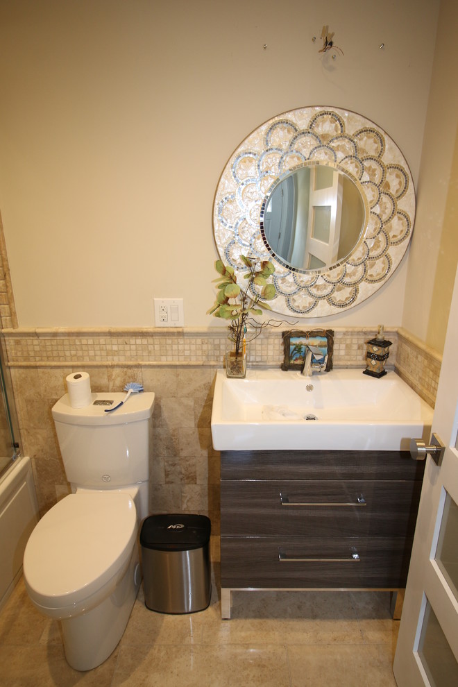 This is an example of a medium sized contemporary family bathroom in New York with a console sink, flat-panel cabinets, brown cabinets, solid surface worktops, a two-piece toilet, beige tiles, stone tiles, beige walls and marble flooring.