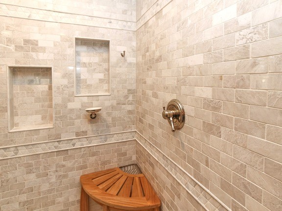 Design ideas for a large traditional ensuite bathroom in Charlotte with shaker cabinets, white cabinets, a freestanding bath, a corner shower, a two-piece toilet, beige tiles, stone tiles, blue walls, porcelain flooring, a submerged sink, marble worktops, brown floors and a hinged door.