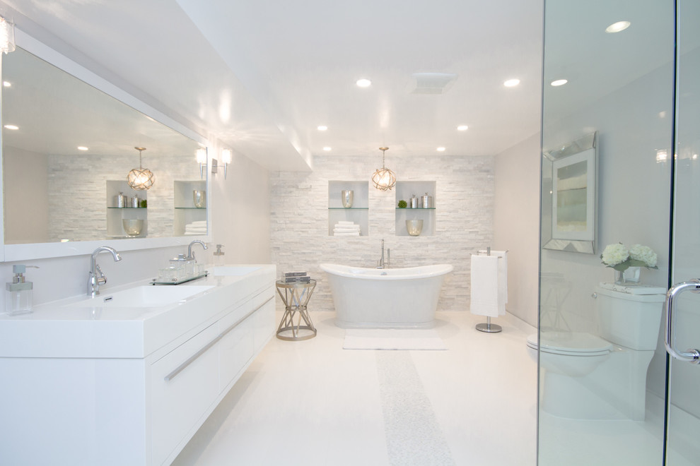 Large trendy master white tile and porcelain tile porcelain tile bathroom photo in Toronto with an integrated sink, flat-panel cabinets, white cabinets, solid surface countertops, a two-piece toilet and gray walls