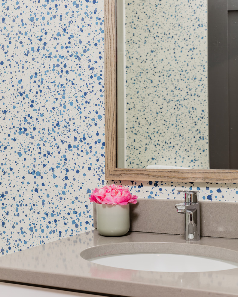 Inspiration for a mid-sized 1960s kids' white tile and stone tile medium tone wood floor alcove shower remodel in Boston with flat-panel cabinets, gray cabinets, a one-piece toilet, blue walls, an undermount sink and quartz countertops