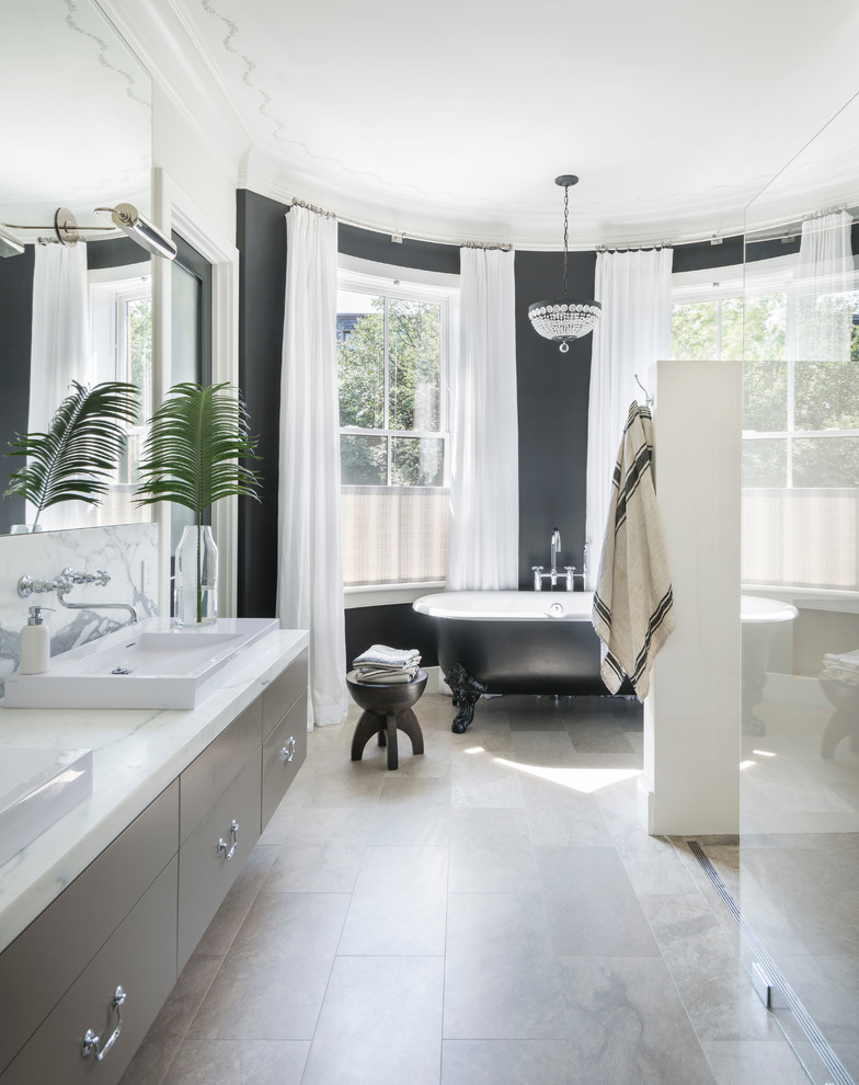 Contemporary bathroom in Boston with flat-panel cabinets, a claw-foot bath, a built-in shower, limestone flooring and a vessel sink.