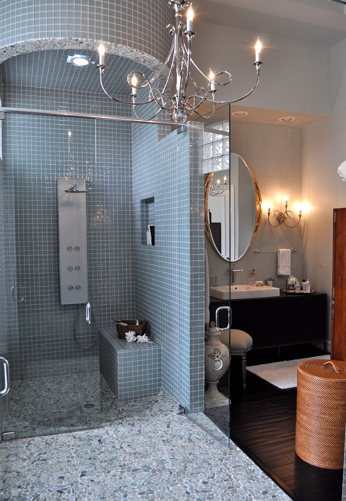 На фото: огромная главная ванная комната в стиле модернизм с фасадами островного типа, темными деревянными фасадами, столешницей из дерева, душем без бортиков, синей плиткой, галечной плиткой, синими стенами и полом из галечной плитки с
