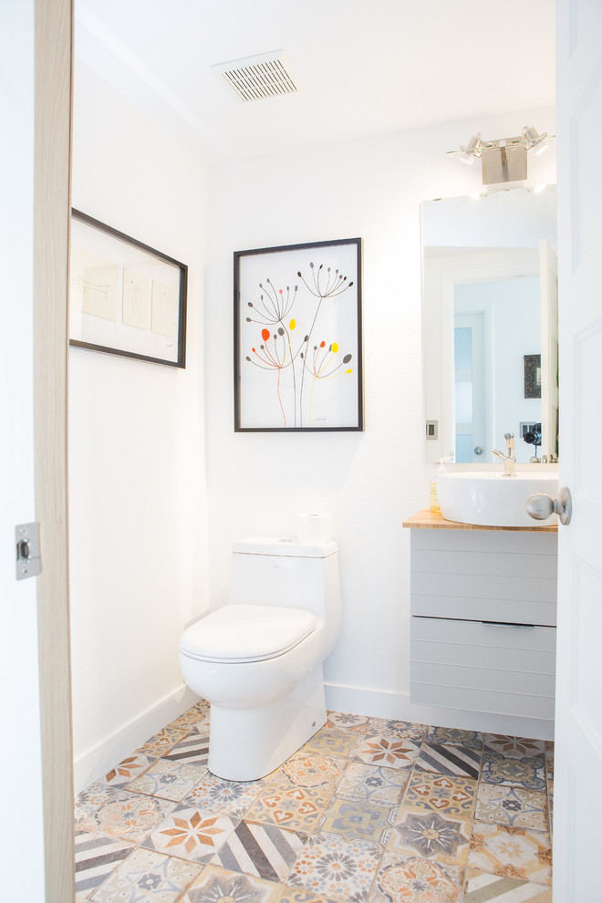 Inspiration for a mid-sized contemporary 3/4 white tile and ceramic tile porcelain tile and multicolored floor bathroom remodel in Denver with flat-panel cabinets, gray cabinets, a one-piece toilet, white walls, a vessel sink, wood countertops and beige countertops