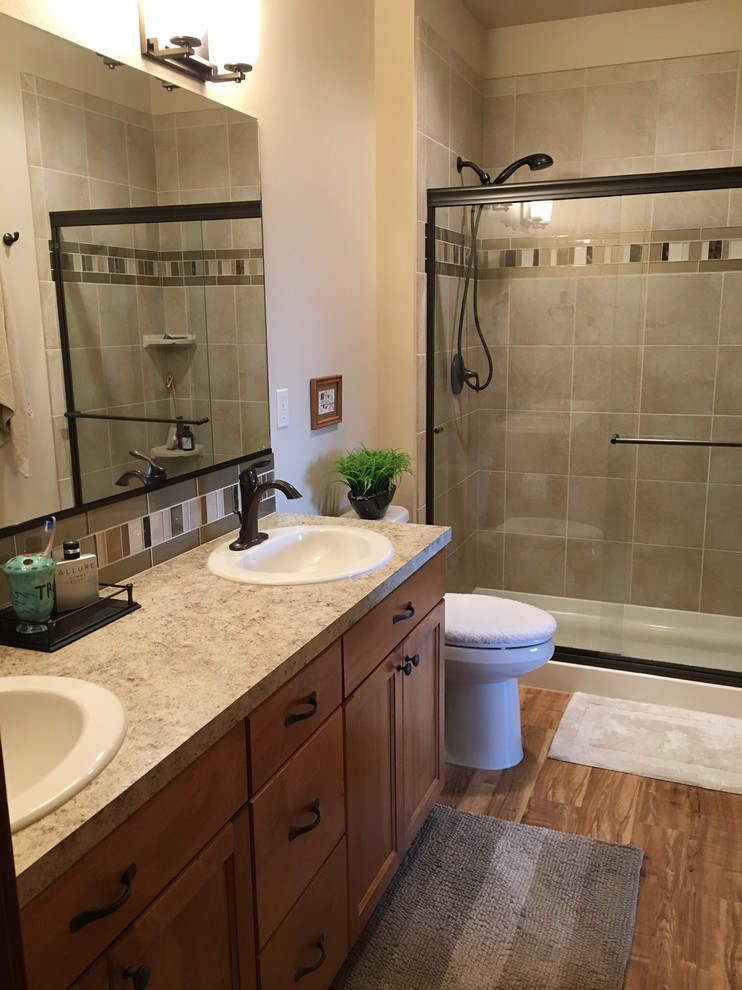 Inspiration for a medium sized traditional bathroom in Seattle with a walk-in shower, a one-piece toilet, beige tiles, porcelain tiles, beige walls, vinyl flooring, a built-in sink and laminate worktops.