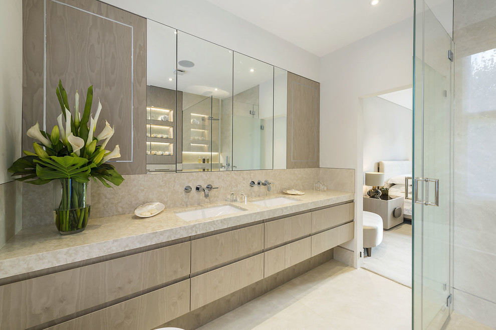 Design ideas for a contemporary ensuite bathroom in London with flat-panel cabinets, light wood cabinets, white walls, a submerged sink, beige floors and beige worktops.