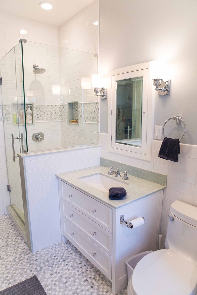 Small transitional kids' multicolored tile and mosaic tile mosaic tile floor corner shower photo in New York with shaker cabinets, white cabinets, a one-piece toilet, gray walls, an undermount sink and quartzite countertops