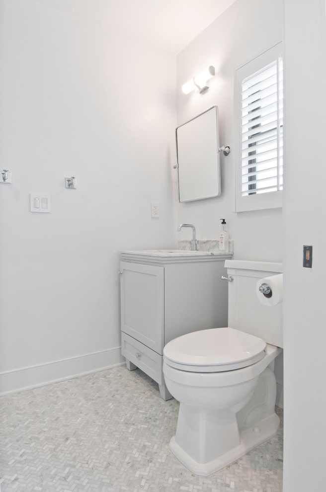 Example of a small transitional 3/4 white tile and marble tile marble floor and multicolored floor bathroom design in Los Angeles with gray cabinets, a one-piece toilet, white walls, an integrated sink and marble countertops