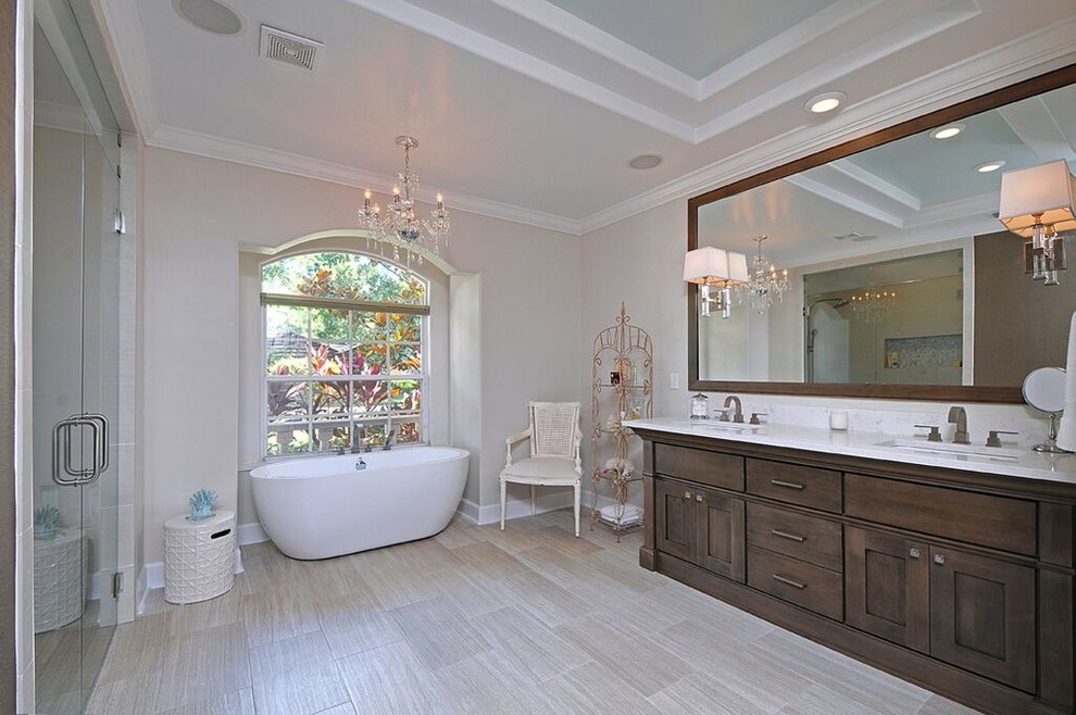 Bathroom - mid-sized shabby-chic style master beige tile and glass tile porcelain tile bathroom idea in Tampa with a vessel sink, furniture-like cabinets, gray cabinets, quartz countertops, a two-piece toilet and gray walls