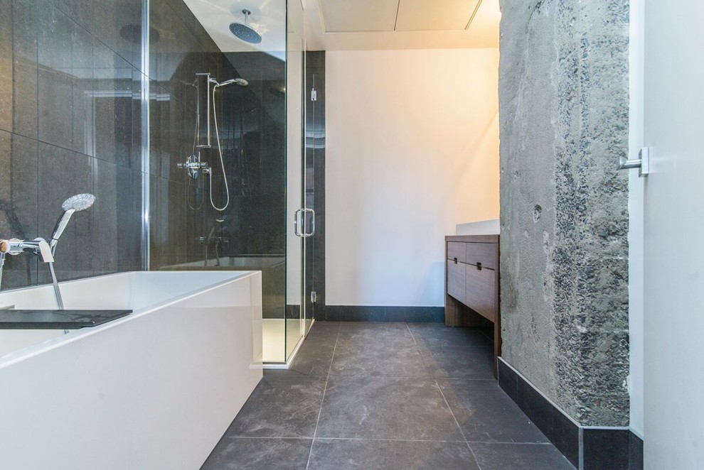 Example of a mid-sized trendy black tile and porcelain tile corner shower design in Montreal with dark wood cabinets, a one-piece toilet, white walls and a vessel sink