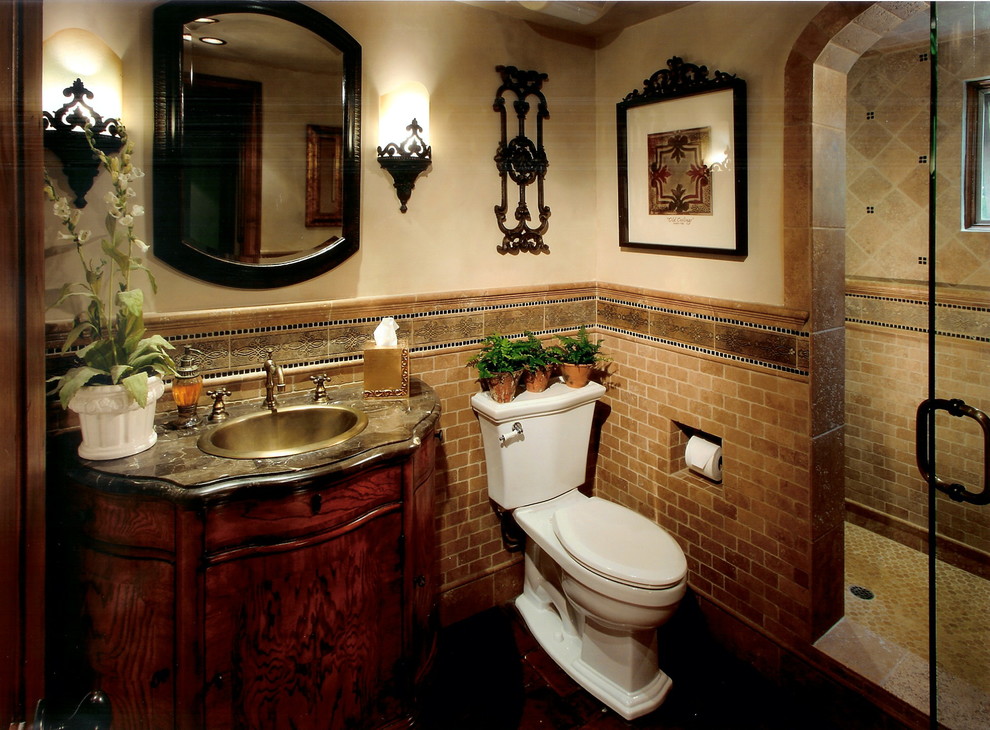 Example of a mid-sized classic 3/4 brown tile and subway tile alcove shower design in Other with furniture-like cabinets, dark wood cabinets, a one-piece toilet, beige walls, a drop-in sink and a hinged shower door