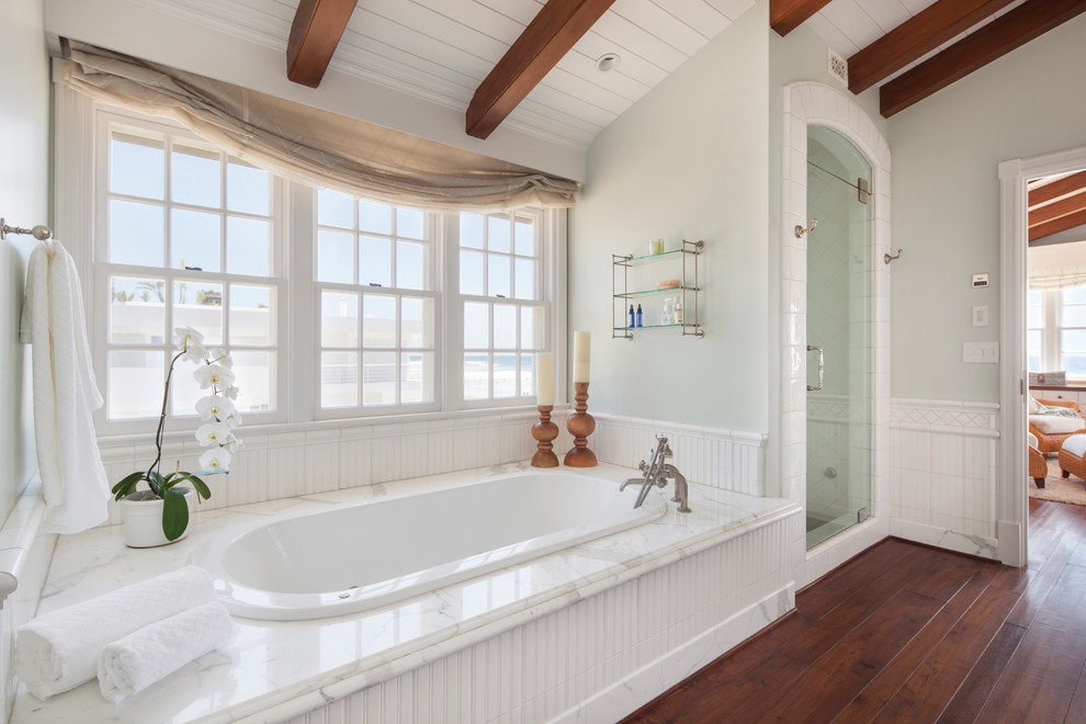 Bathroom - mid-sized coastal master medium tone wood floor bathroom idea in Other with white cabinets, granite countertops, a one-piece toilet, green walls and a hinged shower door
