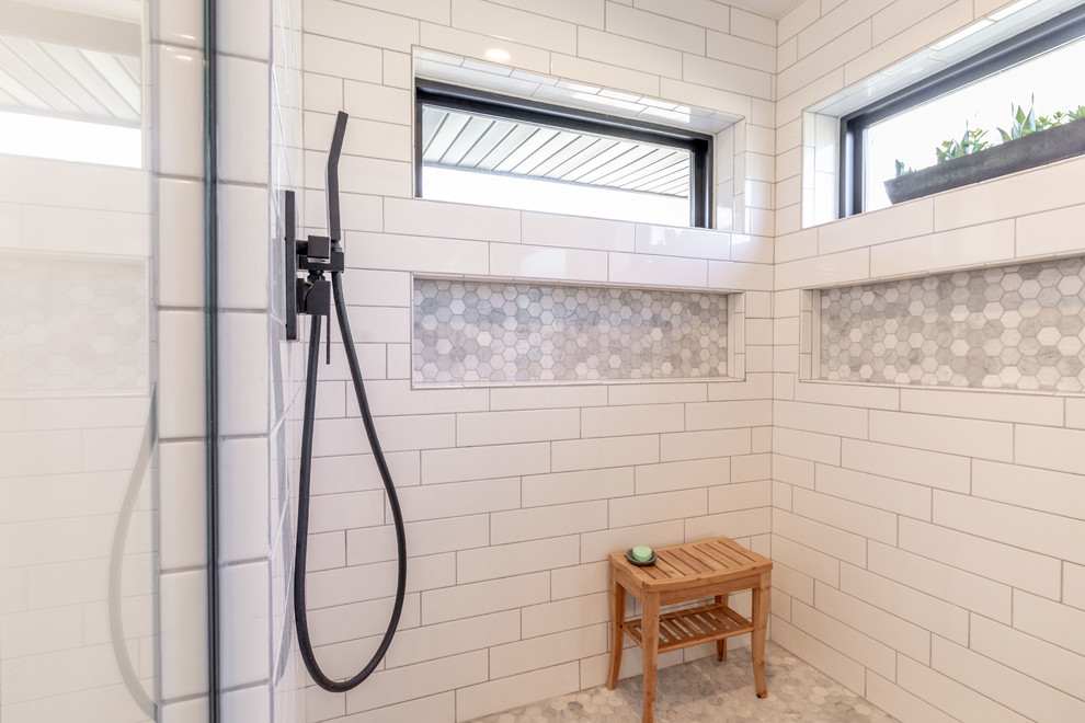 Example of a mid-sized trendy master white tile and subway tile ceramic tile and gray floor bathroom design in Other with flat-panel cabinets, dark wood cabinets, a one-piece toilet, gray walls, an undermount sink, quartz countertops, a hinged shower door and white countertops