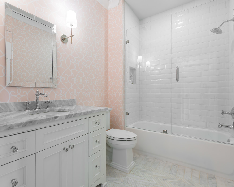 Idée de décoration pour une salle de bain marine avec un placard en trompe-l'oeil, des portes de placard blanches, une baignoire posée, un combiné douche/baignoire, un carrelage blanc, un mur rose, une cabine de douche à porte battante et un plan de toilette gris.